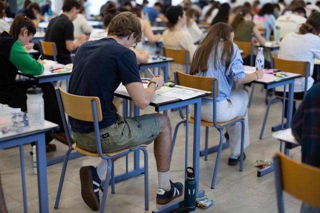 Students start working as a 4 hours philosophy dissertation kicks off the French general baccalaureat exam for getting into university, in Quimper on June 15, 2026. More than 700,000 candidates across France take the 2026 session of the Baccalaureat or "bac", the secondary school diploma required for access to higher education, with written exams running from June 15 to 18 and oral examinations through early July. (Photo by Fred TANNEAU / AFP)