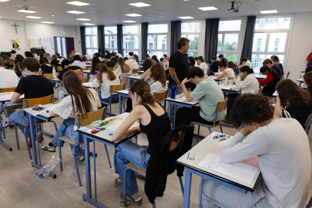 Students start working as a 4 hours philosophy dissertation kicks off the French general baccalaureat exam for getting into university, in Quimper on June 15, 2026. More than 700,000 candidates across France take the 2026 session of the Baccalaureat or "bac", the secondary school diploma required for access to higher education, with written exams running from June 15 to 18 and oral examinations through early July. (Photo by Fred TANNEAU / AFP)