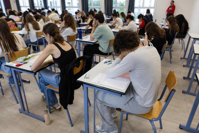 Students start working as a 4 hours philosophy dissertation kicks off the French general baccalaureat exam for getting into university, in Quimper on June 15, 2026. More than 700,000 candidates across France take the 2026 session of the Baccalaureat or "bac", the secondary school diploma required for access to higher education, with written exams running from June 15 to 18 and oral examinations through early July. (Photo by Fred TANNEAU / AFP)