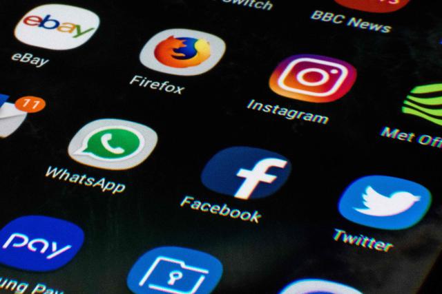 (FILES) This photo illustration shows a mobile phone screen displaying the icons for the social networking apps Facebook, Twitter and Instagram, taken in Manchester on March 22, 2018. British Prime Minister Keir Starmer on June 15, 2026 announced a forthcoming ban on social media for all children under the age of 16. Speaking at a Downing Street press conference, Starmer said that "the government will ban access to social media for all children under the age of 16". (Photo by Oli SCARFF / AFP)