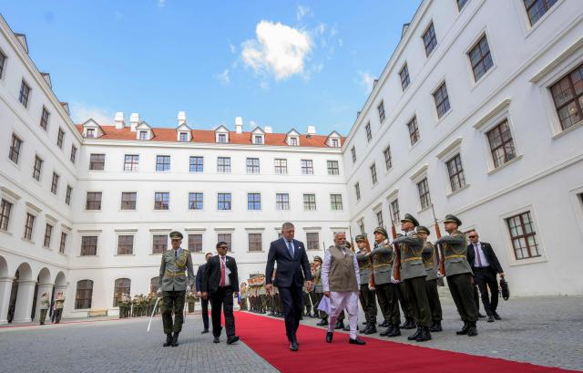Slovakia's prime minister Robert Fico (C-L) and Indian Prime Minister Narendra Modi (C-R) inspect a military guard of honour at Bratislava’s castle in Bratislava, Slovakia, on June 15, 2026. (Photo by Joe Klamar / AFP)