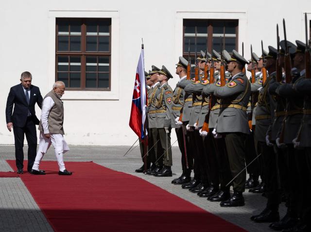 Slovakia's prime minister Robert Fico (L) and Indian Prime Minister Narendra Modi (2nd L) inspect a military guard of honour at Bratislava’s castle in Bratislava, Slovakia, on June 15, 2026. (Photo by Joe Klamar / AFP)