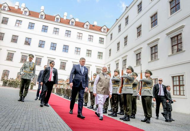 Slovakia's prime minister Robert Fico (C-L) and Indian Prime Minister Narendra Modi (C-R) inspect a military guard of honour at Bratislava’s castle in Bratislava, Slovakia, on June 15, 2026. (Photo by Joe Klamar / AFP)