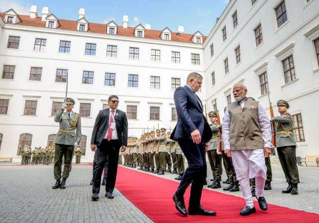 Slovakia's prime minister Robert Fico (C-L) and Indian Prime Minister Narendra Modi (C-R) inspect a military guard of honour at Bratislava’s castle in Bratislava, Slovakia, on June 15, 2026. (Photo by Joe Klamar / AFP)
