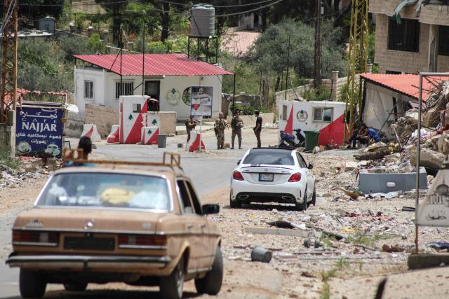 Lebanese soldiers set up a checkpoint in the southern village of Kafra, closing the road leading to the nearby village of Haris, where the Israeli military remains present, on June 15, 2026. Israel's defence minister said on June 15, that Israeli forces would remain in Lebanon, Syria and Gaza indefinitely, hours after the United States and Iran agreed to end the Middle East war, including in Lebanon. (Photo by Kawnat HAJU / AFP) / 