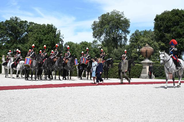 Italy's Prime Minister, Giorgia Meloni (C-R) and Japan's Prime Minister Sanae Takaichi (C-L) review troops before a meeting at Villa Doria Pamphili in Rome on June 15, 2026. (Photo by Andreas SOLARO / AFP)