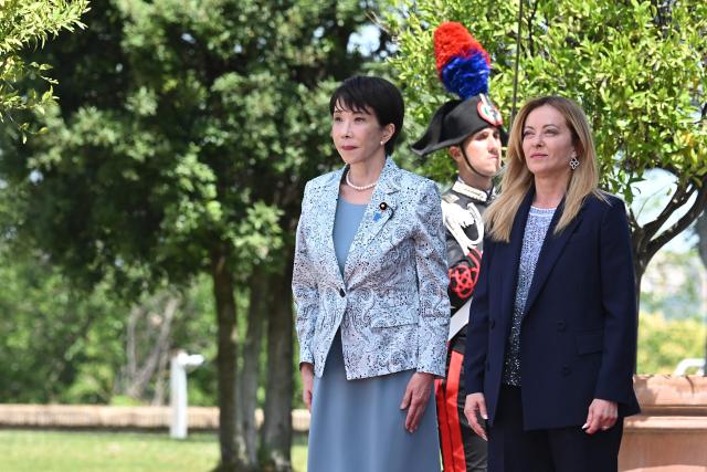Italy's Prime Minister, Giorgia Meloni (R) welcomes Japan's Prime Minister Sanae Takaichi before a meeting at Villa Doria Pamphili in Rome on June 15, 2026. (Photo by Andreas SOLARO / AFP)