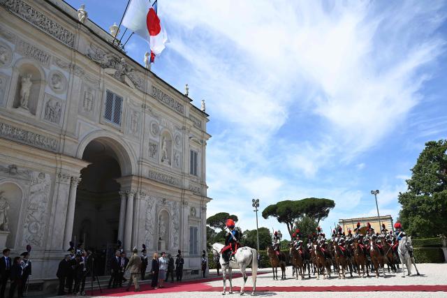 Italy's Prime Minister, Giorgia Meloni (C-L) and Japan's Prime Minister Sanae Takaichi (C-L) review troops before a meeting at Villa Doria Pamphili in Rome on June 15, 2026. (Photo by Andreas SOLARO / AFP)