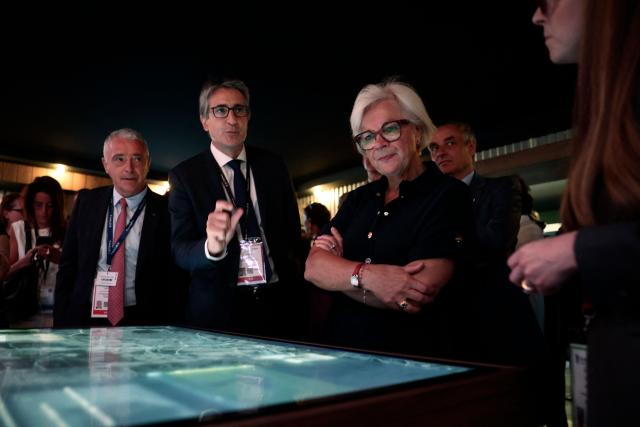 France's Defence Minister Catherine Vautrin (R) listens to Chief Executive Officer of French aerospace and defence group Thales, Patrice Caine (C) at the Thales stand at the Eurosatory land and airland defence and security trade fair, at the Paris-Nord Villepinte Exhibition Centre in Villepinte, north of Paris, on June 15, 2026. (Photo by Guillaume BAPTISTE / AFP)