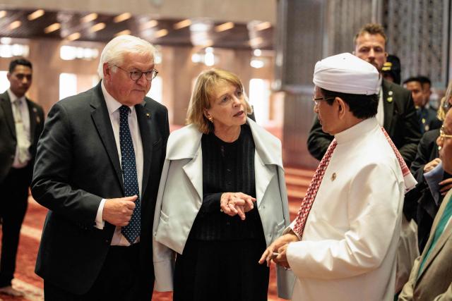 Germany's President Frank-Walter Steinmeier (L) and First Lady Elke Buedenbender (C), accompanied by Indonesia’s Religious Affairs Minister and Grand Imam of Istiqlal Mosque Nasaruddin Umar (R), tour Istiqlal Mosque, Southeast Asia's largest mosque, in Jakarta on June 15, 2026. (Photo by Yasuyoshi Chiba / AFP)