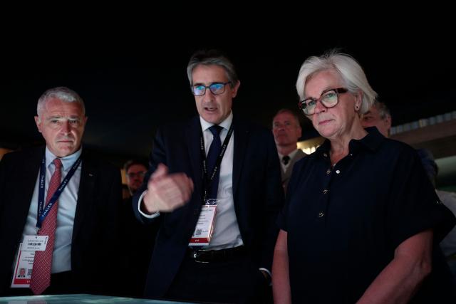 France's Defence Minister Catherine Vautrin (R) listens to Chief Executive Officer of French aerospace and defence group Thales, Patrice Caine (C) at the Thales stand at the Eurosatory land and airland defence and security trade fair, at the Paris-Nord Villepinte Exhibition Centre in Villepinte, north of Paris, on June 15, 2026. (Photo by Guillaume BAPTISTE / AFP)