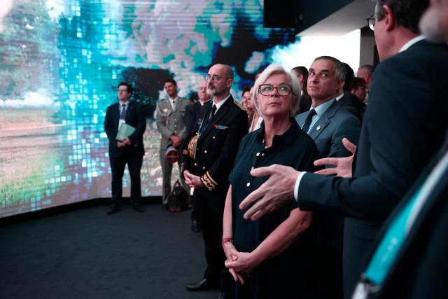 France's Defence Minister Catherine Vautrin (C), next to Cabinet director at France's defence ministry Patrick Pailloux (2ndR), listens to Chief Executive Officer of French aerospace and defence group Thales, Patrice Caine (L, from back) at the Thales stand at the Eurosatory land and airland defence and security trade fair, at the Paris-Nord Villepinte Exhibition Centre in Villepinte, north of Paris, on June 15, 2026. (Photo by Guillaume BAPTISTE / AFP)