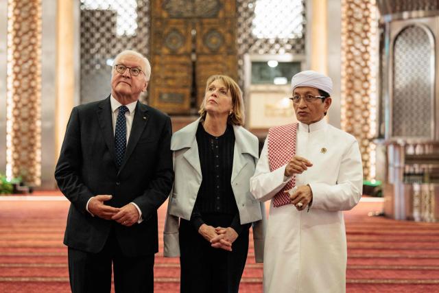 Germany's President Frank-Walter Steinmeier (L) and First Lady Elke Buedenbender (C), accompanied by Indonesia’s Religious Affairs Minister and Grand Imam of Istiqlal Mosque Nasaruddin Umar, tour Istiqlal Mosque, Southeast Asia's largest mosque, in Jakarta on June 15, 2026. (Photo by Yasuyoshi Chiba / AFP)