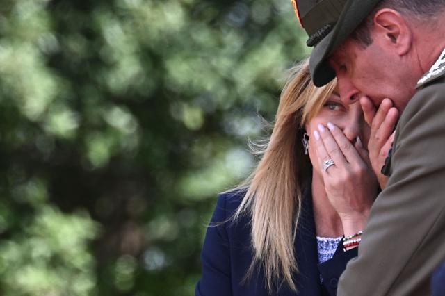 Italy's Prime Minister Giorgia Meloni (L) speaks with her military advisor before a meeting with Japan's Prime Minister at Villa Doria Pamphili in Rome on June 15, 2026. (Photo by Andreas SOLARO / AFP)