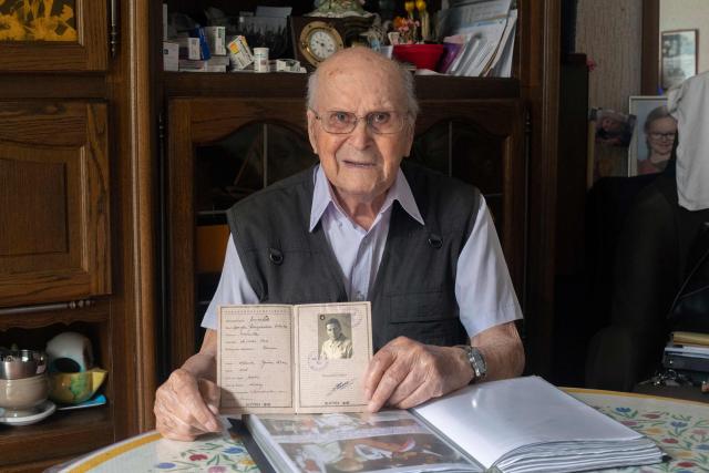 (FILES) Albert Corrieri, 102, an STO (Service du travail obligatoire) (Compulsory work service) victim, shows his prisoner's booklet, the "vorlaufiger fremdenpass", in his flat in Marseille, southeastern France, on June 21, 2024. At the age of 104, Albert Corrieri announced on June 15, 2026 that he was taking his case to the European Court of Human Rights (ECHR) to seek “payment for the hours he worked” in Germany during his years of forced labour in the Second World War. He is claiming Ђ43,200, or Ђ10 per hour, for the period he worked, notably in a chemical factory in Ludwigshafen from 13 March 1943 to 15 April 1945. (Photo by Jйrйmy PAOLONI / AFP)