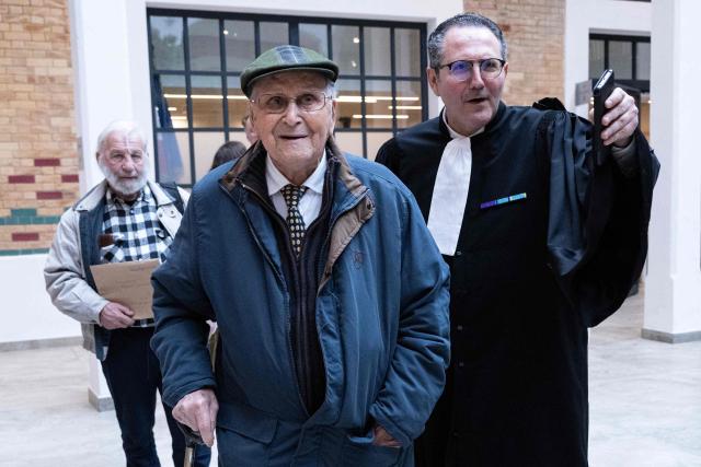 (FILES) Plaintiff Albert Corrieri (L), 102, leaves the court with his lawyer Michel Pautot (R) after his trial against French state demanding compensation of the hours he worked in Nazi Germany during World War II as part of the STO Compulsory Labour Service, in Marseille on February 25, 2025. At the age of 104, Albert Corrieri announced on June 15, 2026 that he was taking his case to the European Court of Human Rights (ECHR) to seek “payment for the hours he worked” in Germany during his years of forced labour in the Second World War. He is claiming Ђ43,200, or Ђ10 per hour, for the period he worked, notably in a chemical factory in Ludwigshafen from 13 March 1943 to 15 April 1945. (Photo by Miguel MEDINA / AFP)