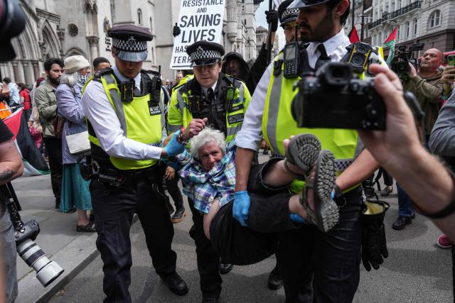 Police remove protesters from outside the Royal Courts Of Justice in central London on June 15, 2026, as the High Court ruled on a legal standoff between the government and activist group Palestine Action. London's Court of Appeal on June 15 upheld a government ban on the Palestine Action activist group imposed under terrorism legislation, following a legal challenge. (Photo by CARLOS JASSO / AFP)