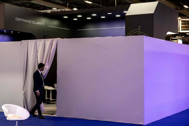 A security staff enters the closed stand of Israeli developer and manufacturer of defence and surveillance Electro-optic infrared (EO/IR) systems Controp at the Eurosatory land and airland defence and security trade fair, at the Paris-Nord Villepinte Exhibition Centre in Villepinte, north of Paris on June 15, 2026. Twelve Israeli stands were closed at the Eurosatory defence and security exhibition, which opened on today, for failing to comply with the conditions that had been set, according to a statement received by AFP from the organising company, Coges Events. (Photo by Guillaume BAPTISTE / AFP)