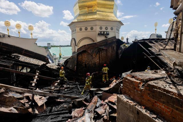 Ukrainian firefighters work at the roof of the damaged Dormition Cathedral in the Orthodox complex of the Kyiv Pechersk Lavra following a Russian missile and drone strike in Kyiv on June 15, 2026, amid the Russian invasion of Ukraine. Russia fired a barrage of missiles at several major Ukrainian cities, setting fire to Kyiv's historic Dormition Cathedral at the UNESCO world heritage site Kyiv-Pechersk Lavra, and killing at least eleven across Ukraine, while Ukraine strikes claimed three lives in a city south of Moscow. (Photo by Tetiana DZHAFAROVA / AFP)