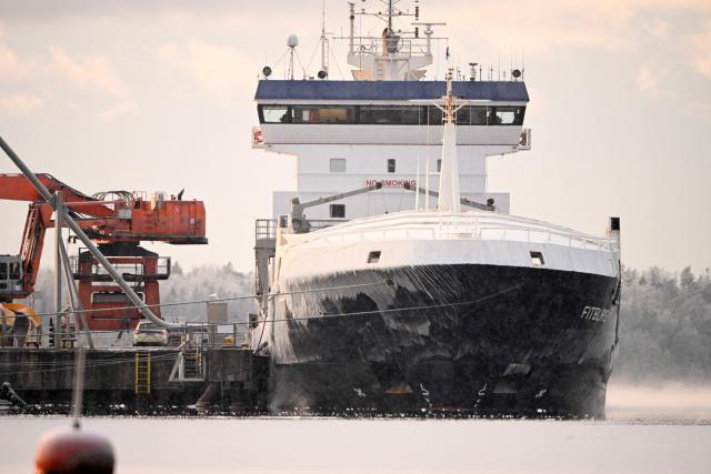 (FILES) This file photo shows the seized vessel Fitburg  moored at the harbour in Kirkkonummi, Finland, on January 1, 2026. Finland on June 15, 2026 charged the Russian captain and a senior crew member of a ship suspected of damaging two subsea cables linking Finland and Estonia on New Year's Eve, authorities said. The Fitburg, a 132-metre-long (433-feet-long) cargo ship en route from Russia to Israel, was stopped by Finnish authorities on December 31, 2025 following suspicions that the ship's anchor had damaged the two telecoms cables in the Gulf of Finland. The incident is one of several instances of suspected cable sabotage in the Baltic Sea viewed by many experts and politicians as part of Russia's "hybrid war" against Western countries, at a time of high tensions over Russia's invasion of Ukraine. (Photo by Roni Rekomaa / Lehtikuva / AFP) / Finland OUT