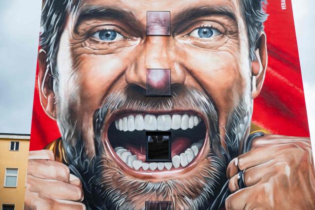 A mural advertising a US beer brand features a likeness of former German football coach Juergen Klopp, in Berlin on June 15, 2026. (Photo by John MACDOUGALL / AFP)