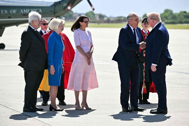 Former Speaker of the United States House of Representatives Newt Gingrich, his wife United States Ambassador to Switzerland Callista Gingrich (2L), President of the Council of State of Geneva Anne Hiltpold (3L) and Switzerland's President Guy Parmelin (2R) welcome US President Donald Trump (R) after landing at the Geneva airport ahead of the G7 summit, in Geneva on June 15, 2026. A G7 summit is set to take place June 15 to 17 in the French town of Evian-les-Bains near Switzerland and it will be attended by country leaders as well as the EU's foreign policy chief and ministers from Brazil, Canada, the United Arab Emirates and Turkey. (Photo by Mandel NGAN / AFP)