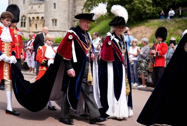 Britain's King Charles III (C) and Britain's Queen Camilla (R) attend the annual Order of the Garter service at St. George's Chapel in Windsor Castle, west of London, on June 15, 2026. The Order of the Garter is the oldest and most senior Order of Chivalry in Britain, established by King Edward III nearly 700 years ago. (Photo by Aaron Chown / POOL / AFP)