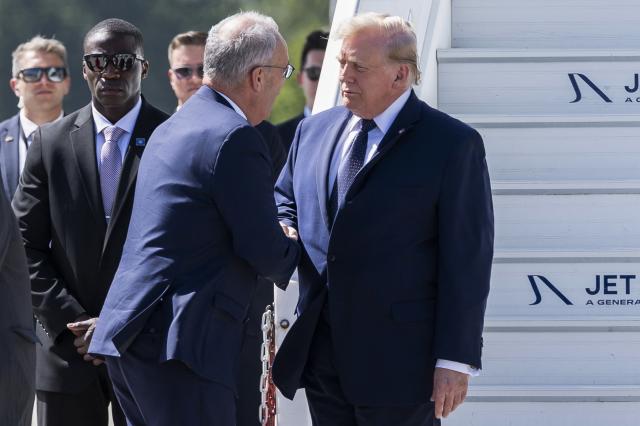 Switzerland's President Guy Parmelin (C-L) welcomes US President Donald Trump (C-R) after landing at the Geneva airport ahead of the G7 summit, in Geneva on June 15, 2026. A G7 summit is set to take place June 15 to 17 in the French town of Evian-les-Bains near Switzerland and it will be attended by country leaders as well as the EU's foreign policy chief and ministers from Brazil, Canada, the United Arab Emirates and Turkey. (Photo by MARTIAL TREZZINI / POOL / AFP)