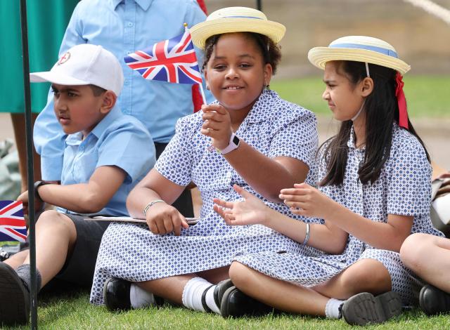 School children with a Union Jack flag attend the annual Order of the Garter service at St. George's Chapel in Windsor Castle, west of London, on June 15, 2026. The Order of the Garter is the oldest and most senior Order of Chivalry in Britain, established by King Edward III nearly 700 years ago. (Photo by Chris Jackson / POOL / AFP)