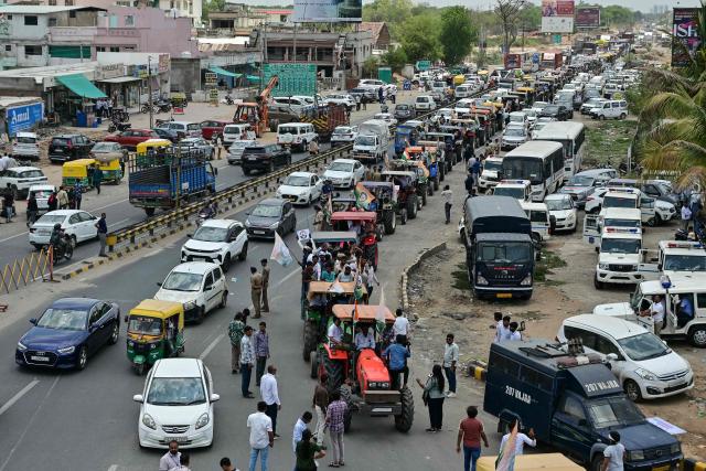 Farmers take part in a tractor march demanding the availability of fertiliser and protesting against hiked fuel prices in Ahmedabad on June 15, 2026. (Photo by Shammi MEHRA / AFP)
