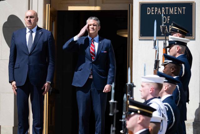 US Secretary of Defense Pete Hegseth and Italian Defense Minister Guido Crosetto (L), listen as national anthems are played during an honor cordon welcoming ceremony at the Pentagon in Washington, DC on June 15, 2026. (Photo by SAUL LOEB / AFP)