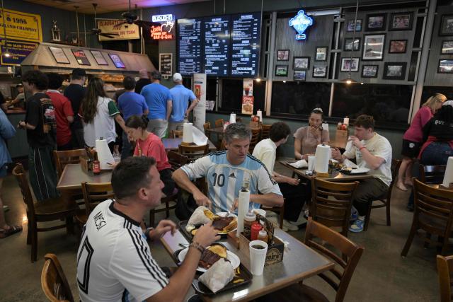 Argentina supporters dine at Joe's Kansas City  BAR-B-QUE barbecue restaurant in Kansas City, Missouri, United States on June 14, 2026, ahead of the 2026 World Cup football match between Argentina and Algeria. (Photo by JUAN MABROMATA / AFP)