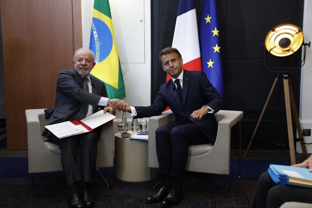 Brazil's President Luiz Inacio Lula da Silva (L) and France's President Emmanuel Macron pose ahead of a bilateral meeting on the sidelines of the G7 summit, in Evian, eastern France, on June 15, 2026. A G7 summit is set to take place June 15 to 17 in the French town of Evian-les-Bains near Switzerland and it will be attended by country leaders as well as the EU's foreign policy chief and ministers from Brazil, Canada, the United Arab Emirates and Turkey. (Photo by Yoan VALAT / POOL / AFP)