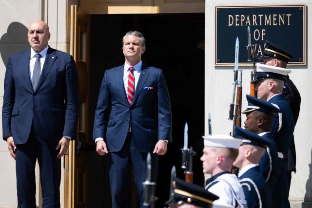 US Secretary of Defense Pete Hegseth and Italian Defense Minister Guido Crosetto (L), listen as national anthems are played during an honor cordon welcoming ceremony at the Pentagon in Washington, DC on June 15, 2026. (Photo by SAUL LOEB / AFP)