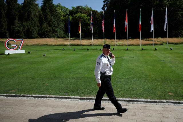 A member of the security walks outside ahead of the G7 summit, in Evian, eastern France, on June 15, 2026. A G7 summit is set to take place June 15 to 17 in the French town of Evian-les-Bains near Switzerland and it will be attended by country leaders as well as the EU's foreign policy chief and ministers from Brazil, Canada, the United Arab Emirates and Turkey. (Photo by Isabel Infantes / POOL / AFP)