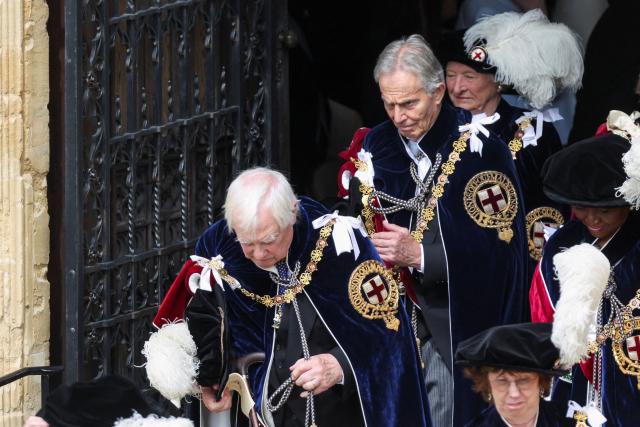 Britain's former prime minister Tony Blair (top C) and Chris Patten (bottom L), the last governor of Hong Kong, depart after attending the annual Order of the Garter service at St. George's Chapel in Windsor Castle, west of London, on June 15, 2026. The Order of the Garter is the oldest and most senior Order of Chivalry in Britain, established by King Edward III nearly 700 years ago. (Photo by Toby Shepheard / POOL / AFP)
