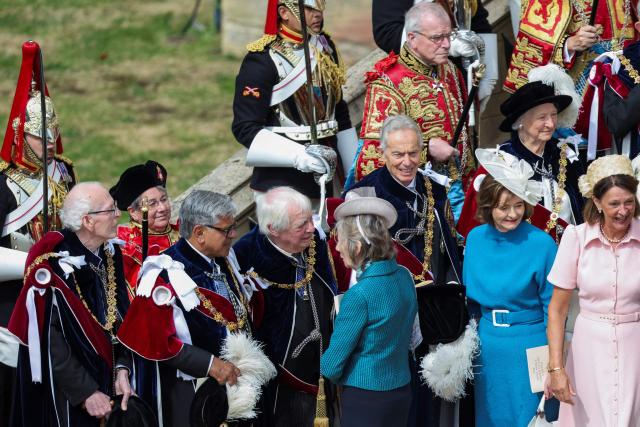 Britain's former prime minister Tony Blair (centre R), his wife Cherie Blair (2nd R) and Chris Patten (4th L), the last governor of Hong Kong, depart after attending the annual Order of the Garter service at St. George's Chapel in Windsor Castle, west of London, on June 15, 2026. The Order of the Garter is the oldest and most senior Order of Chivalry in Britain, established by King Edward III nearly 700 years ago. (Photo by Toby Shepheard / POOL / AFP)