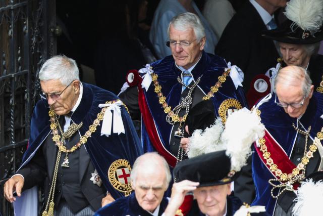 Britain's former prime minister John Major (top C) and other guests depart after attending the annual Order of the Garter service at St. George's Chapel in Windsor Castle, west of London, on June 15, 2026. The Order of the Garter is the oldest and most senior Order of Chivalry in Britain, established by King Edward III nearly 700 years ago. (Photo by Toby Shepheard / POOL / AFP)