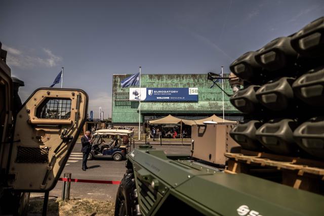 Visitors walk by military vehicles displayed at the Eurosatory land and airland defence andsecurity trade fair, at the Paris-Nord Villepinte Exhibition Centre in Villepinte, north of Paris on June 15, 2026. Twelve Israeli stands were closed at the Eurosatory defence and security exhibition, which opened on today, for failing to comply with the conditions that had been set, according to a statement received by AFP from the organising company, Coges Events. (Photo by Guillaume BAPTISTE / AFP)