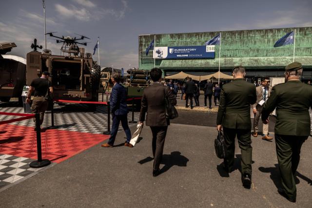 Visitors walk by military vehicles displayed at the Eurosatory land and airland defence andsecurity trade fair, at the Paris-Nord Villepinte Exhibition Centre in Villepinte, north of Paris on June 15, 2026. Twelve Israeli stands were closed at the Eurosatory defence and security exhibition, which opened on today, for failing to comply with the conditions that had been set, according to a statement received by AFP from the organising company, Coges Events. (Photo by Guillaume BAPTISTE / AFP)