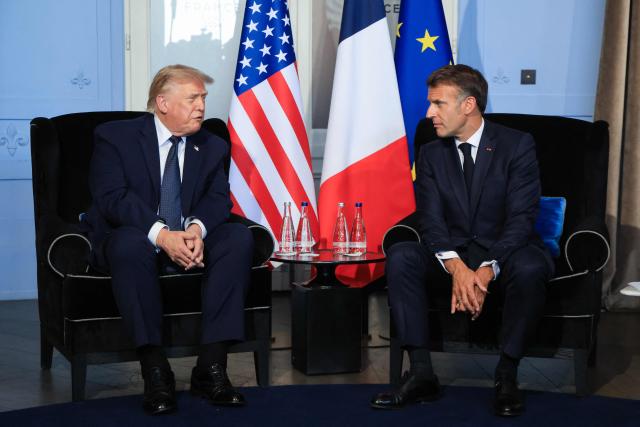 US President Donald Trump (L) attends a bilateral meeting with France's President Emmanuel Macron on the sidelines of the G7 summit, in Evian, central-eastern France on June 15, 2026. A G7 summit is set to take place June 15 to 17 in the French town of Evian-les-Bains near Switzerland and it will be attended by country leaders as well as the EU's foreign policy chief and ministers from Brazil, Canada, the United Arab Emirates and Turkey. (Photo by Ludovic MARIN / POOL / AFP)