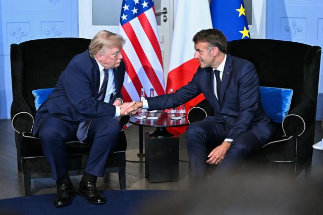 US President Donald Trump (L) shakes hands with France's President Emmanuel Macron during a bilateral meeting on the sidelines of the G7 summit, in Evian, central-eastern France on June 15, 2026. A G7 summit is set to take place June 15 to 17 in the French town of Evian-les-Bains near Switzerland and it will be attended by country leaders as well as the EU's foreign policy chief and ministers from Brazil, Canada, the United Arab Emirates and Turkey. (Photo by Mandel NGAN / AFP)