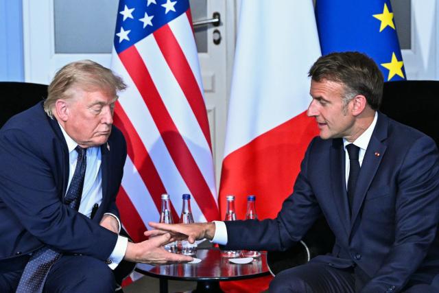 US President Donald Trump (L) shakes hands with France's President Emmanuel Macron during a bilateral meeting on the sidelines of the G7 summit, in Evian, central-eastern France on June 15, 2026. A G7 summit is set to take place June 15 to 17 in the French town of Evian-les-Bains near Switzerland and it will be attended by country leaders as well as the EU's foreign policy chief and ministers from Brazil, Canada, the United Arab Emirates and Turkey. (Photo by Mandel NGAN / AFP)