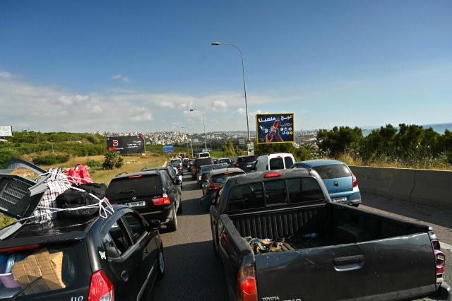 Traffic slowly moves along the highway through the area of Jiyeh as families return to their home villages in southern Lebanon on June 15, 2026. Israel's defence minister said on June 15 that Israeli forces would remain in Lebanon, Syria and Gaza indefinitely, hours after the United States and Iran agreed to end the Middle East war, including in Lebanon.  Lebanon was drawn into the Middle East war on March 2 when Tehran-backed militant group Hezbollah launched attacks on Israel to avenge the killing of the Iranian leader. Israel has responded with broad strikes across Lebanon and a ground offensive. (Photo by FADEL itani / AFP) / 