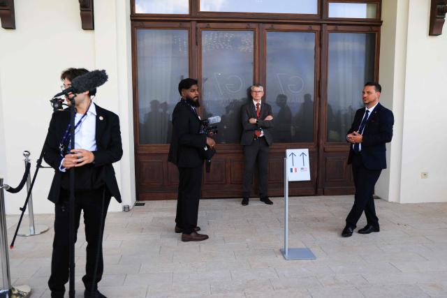 Journalists wait for the bilateral meeting between France's President and US President on the sidelines of the G7 summit, in Evian, central-eastern France on June 15, 2026. A G7 summit is set to take place June 15 to 17 in the French town of Evian-les-Bains near Switzerland and it will be attended by country leaders as well as the EU's foreign policy chief and ministers from Brazil, Canada, the United Arab Emirates and Turkey. (Photo by Ludovic MARIN / POOL / AFP)