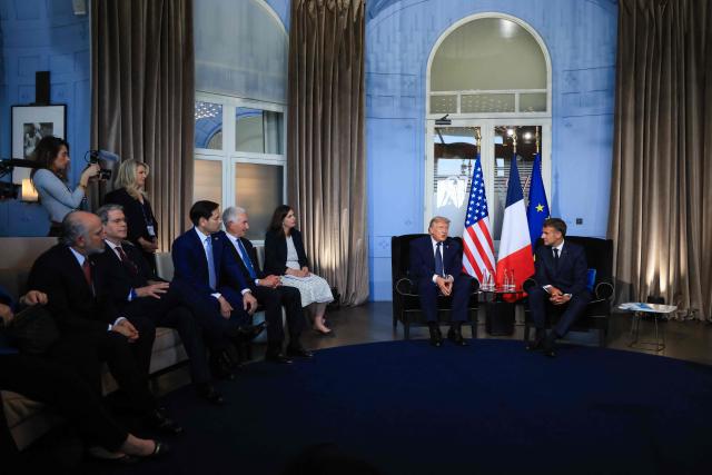 US President Donald Trump (C-L) attends a bilateral meeting with France's President Emmanuel Macron (C-R), US' Commerce secretary Howard Lutnick (L), US Secretary of Treasury Scott Bessent (2L), US Secretary of State Marco Rubio (3L) and US ambassador to France Charles Kushner (4L) on the sidelines of the G7 summit, in Evian, central-eastern France on June 15, 2026. A G7 summit is set to take place June 15 to 17 in the French town of Evian-les-Bains near Switzerland and it will be attended by country leaders as well as the EU's foreign policy chief and ministers from Brazil, Canada, the United Arab Emirates and Turkey. (Photo by Ludovic MARIN / POOL / AFP)