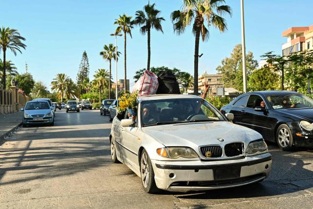 A vehicle laden with household items drives along the highway of the coastal city of Sidon as displaced families return to their home villages in southern Lebanon on June 15, 2026. Israel's defence minister said on June 15 that Israeli forces would remain in Lebanon, Syria and Gaza indefinitely, hours after the United States and Iran agreed to end the Middle East war, including in Lebanon.  Lebanon was drawn into the Middle East war on March 2 when Tehran-backed militant group Hezbollah launched attacks on Israel to avenge the killing of the Iranian leader. Israel has responded with broad strikes across Lebanon and a ground offensive. (Photo by FADEL itani / AFP) / 