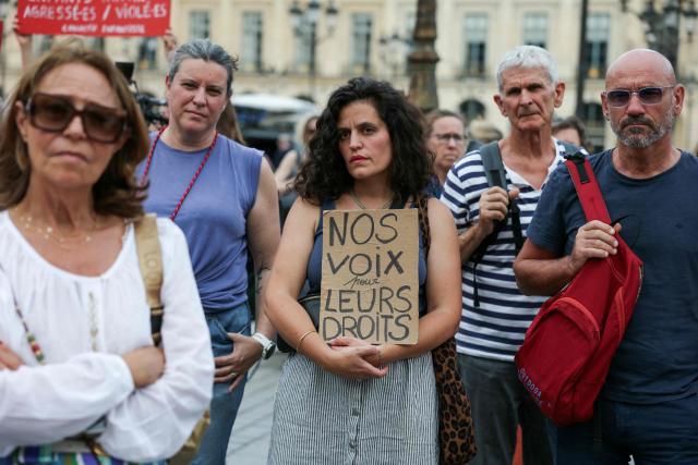 A protestor holds a slogan reading "Our voice for their rights" during a gathering to demand a law against violence on minors, outside the French Justice Ministry, in Place Vendome, in Paris on June 15, 2026. (Photo by Thomas SAMSON / AFP)
