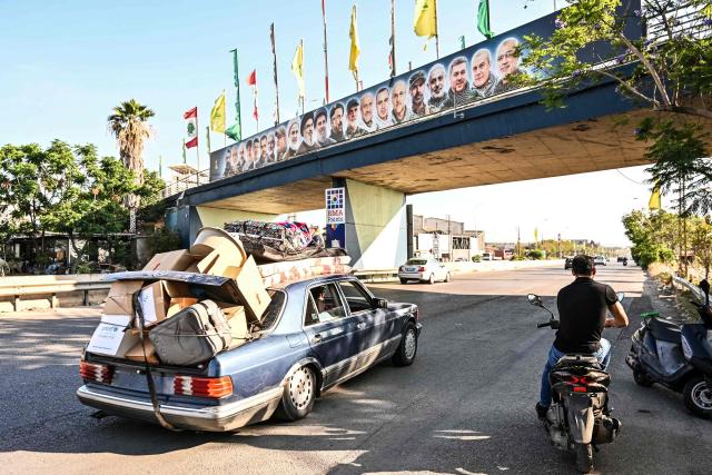 A car laden with house items drives along the highway through the area of of the coastal town of Ghazieyh as families return to their home villages in southern Lebanon on June 15, 2026. Israel's defence minister said on June 15 that Israeli forces would remain in Lebanon, Syria and Gaza indefinitely, hours after the United States and Iran agreed to end the Middle East war, including in Lebanon.  Lebanon was drawn into the Middle East war on March 2 when Tehran-backed militant group Hezbollah launched attacks on Israel to avenge the killing of the Iranian leader. Israel has responded with broad strikes across Lebanon and a ground offensive. (Photo by FADEL itani / AFP) / 