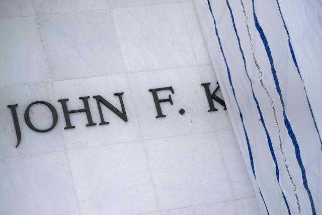 Some of the lettering is seen as a tarp covers signage on the facade of the Kennedy Center in Washington, DC, on June 15, 2026, after a judge ordered the removal of US President Donald Trump's name from the building. Workers removed President Donald Trump's name from the facade of the prestigious Kennedy Center in Washington on June 13 -- a stinging defeat for the US leader who has eschewed political tradition to affix his name and likeness across public spaces. (Photo by Brendan Smialowski / AFP)